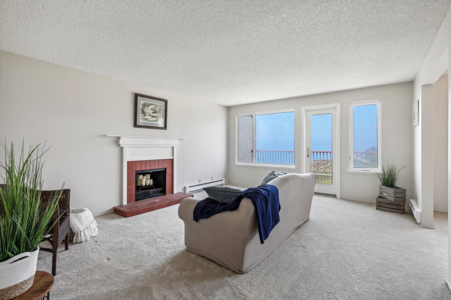 5003 Palmetto Avenue, Unit 89 Pacifica, CA 94044 - Photo 9 of 46 a living room with furniture and a fireplace