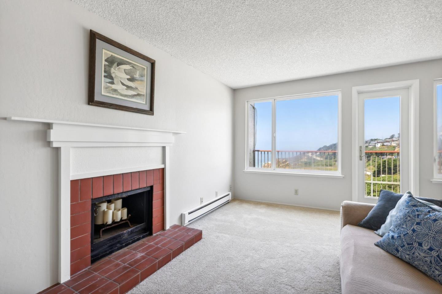 5003 Palmetto Avenue, Unit 89 Pacifica, CA 94044 - Photo 10 of 46 a living room with furniture and a fireplace