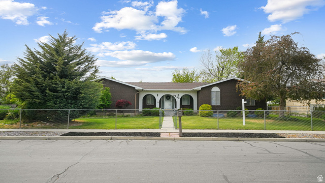 9556 South David Street Sandy, UT 84070 - Photo 1 of 1 Ranch-style house featuring a fenced front yard and brick siding