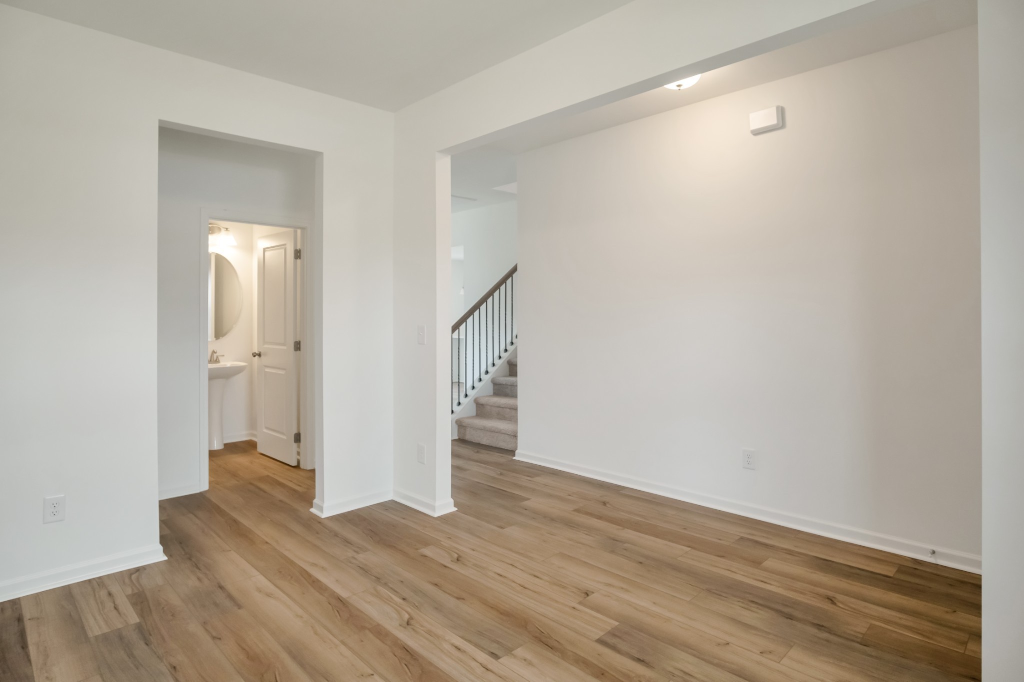 769 Chiswick Court Lebanon, TN 37087 - Photo 11 of 44 a view of an empty room with wooden floor and a window