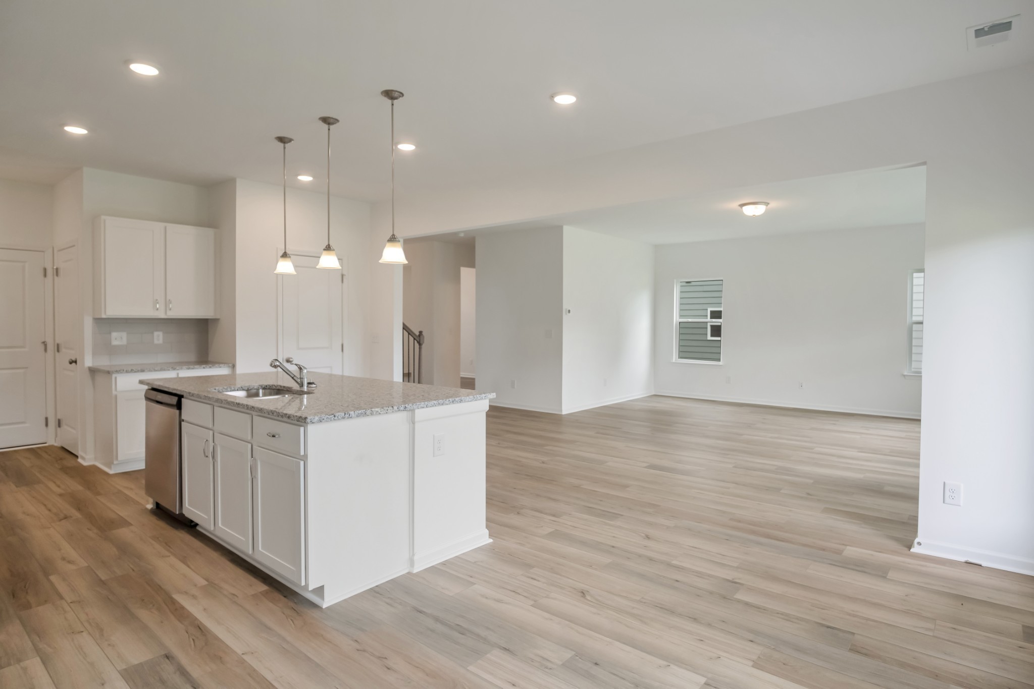 769 Chiswick Court Lebanon, TN 37087 - Photo 17 of 44 a kitchen with stainless steel appliances granite countertop wooden floors and white walls