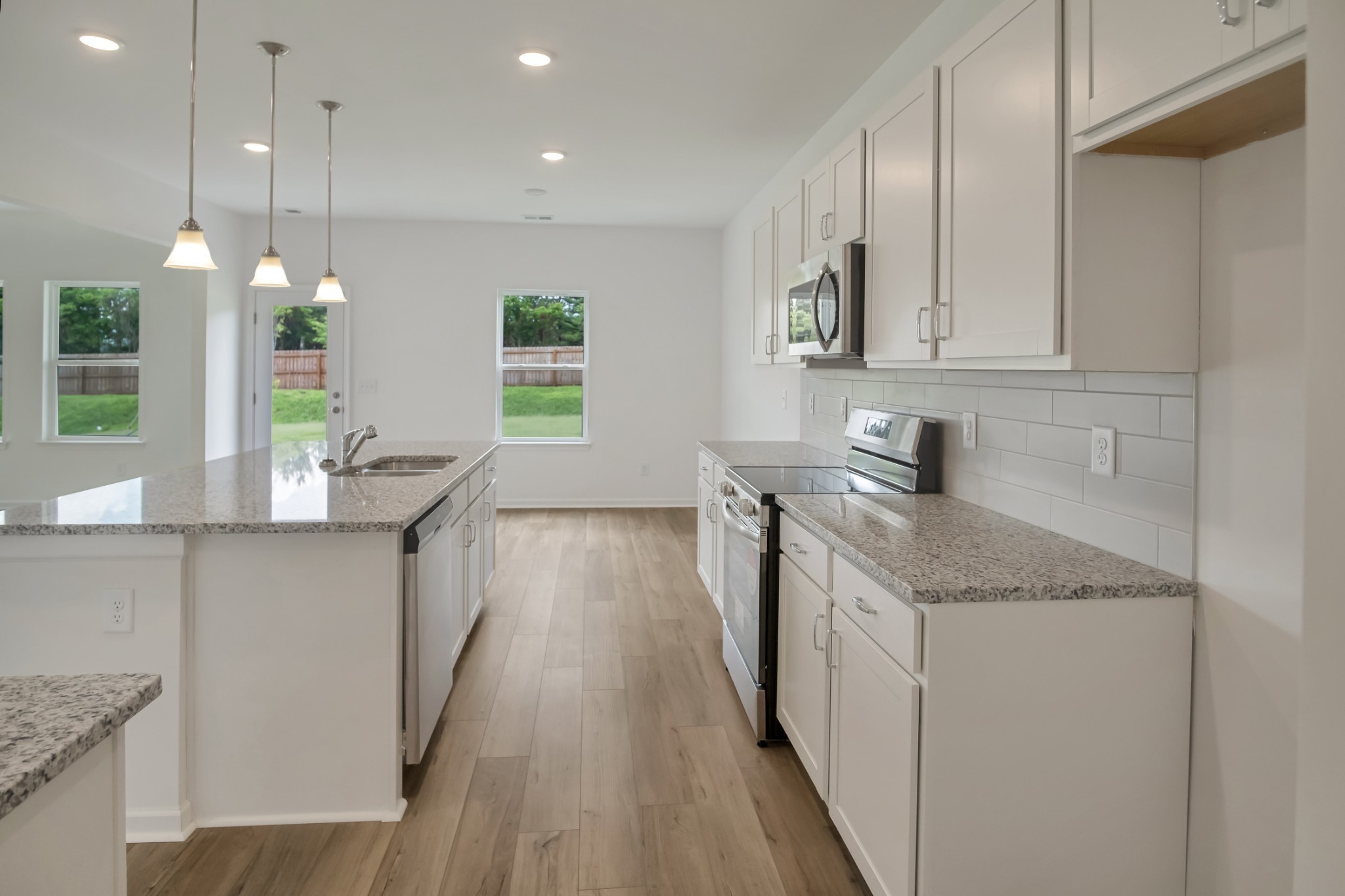 769 Chiswick Court Lebanon, TN 37087 - Photo 18 of 44 a kitchen with granite countertop a sink a counter space appliances and cabinets