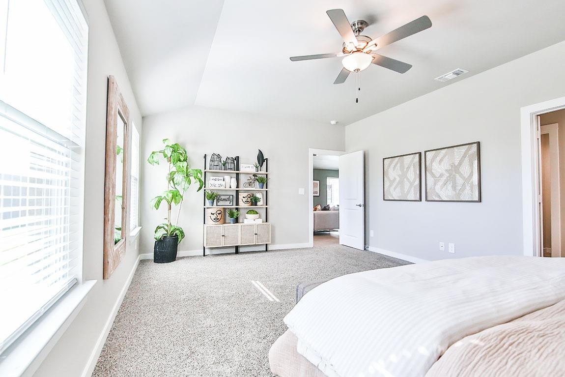 7735 92nd Street Lubbock, TX 79424 - Photo 4 of 12 a bedroom with a large bed and a window