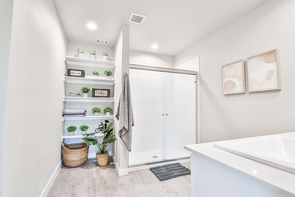 7735 92nd Street Lubbock, TX 79424 - Photo 6 of 12 a bathroom with a sink a mirror and a shower