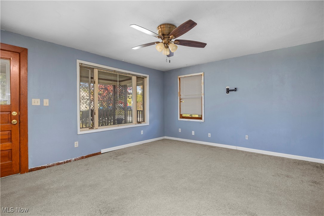 6927 North Wildacre Road Curtice, OH 43412 - Photo 14 of 44 Carpeted empty room with baseboards and ceiling fan
