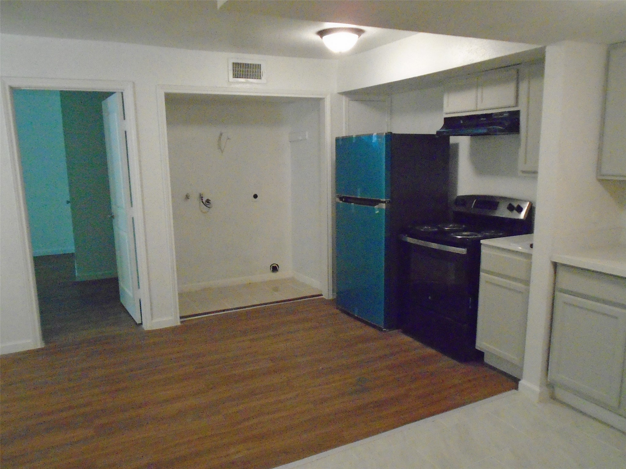 9898 Club Creek Drive, Unit 1817 Houston, TX 77036 - Photo 7 of 8 a view of a kitchen with wooden cabinets