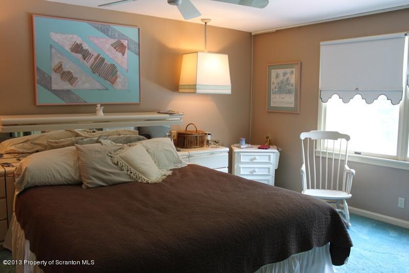 311 Lockville Road Falls, PA 18615 - Photo 8 of 19 a bedroom with a bed and a painting on the wall