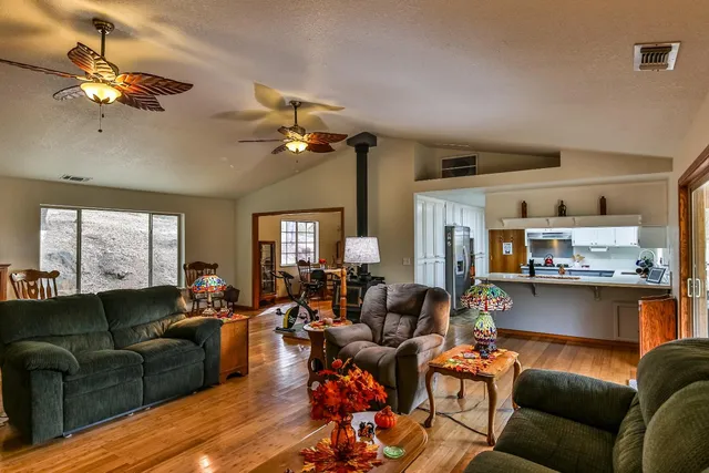 a bedroom with a bed and a flat tv screen on dresser