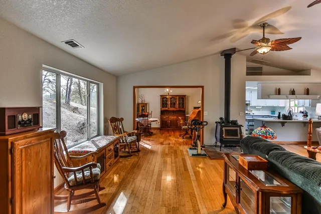 a living room with furniture a chandelier and a window
