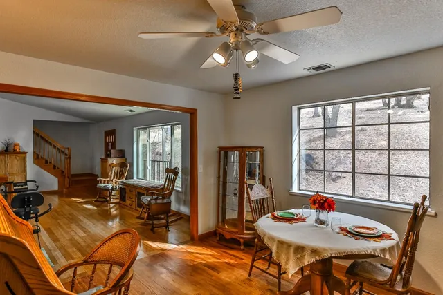 a living room with furniture kitchen view and a large window
