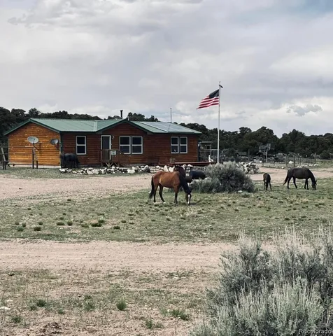 a view of a house with a yard and sitting area