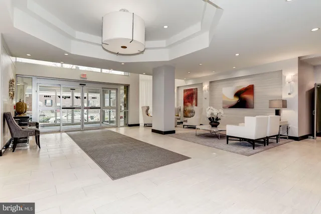 a living room with furniture a chandelier and a flat screen tv
