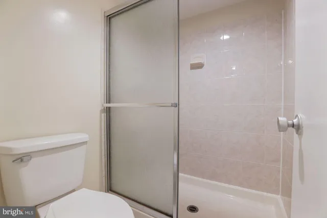 a white toilet sitting next to a bath tub