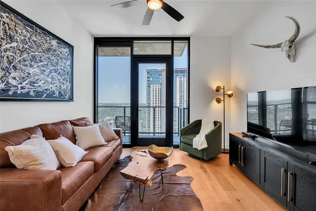 a living room with furniture fireplace and flat screen tv