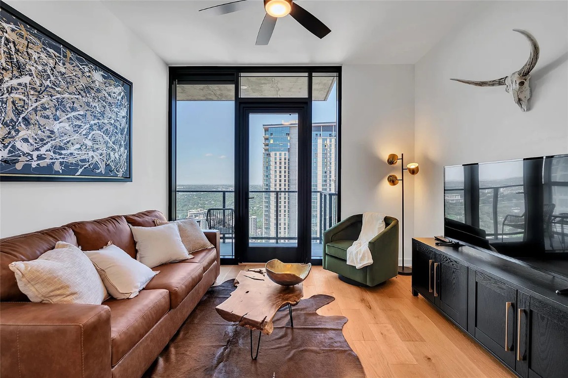 a living room with furniture fireplace and flat screen tv