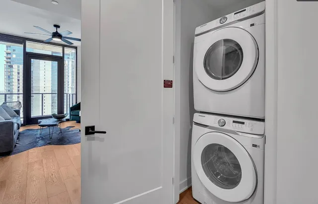 a view of a bedroom with washer and dryer
