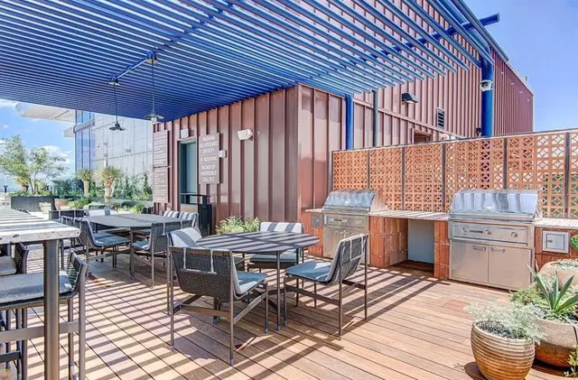 a patio with glass top table and chairs