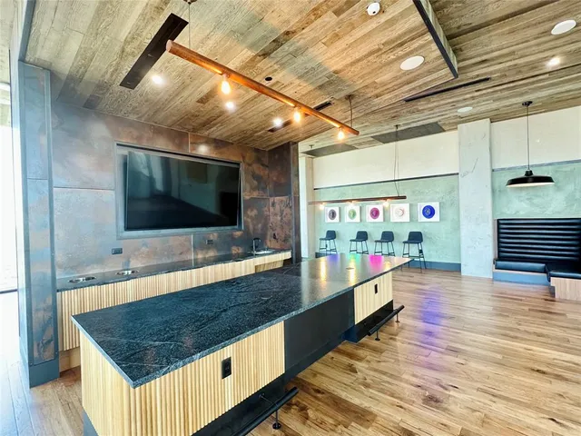 a living room with a flat screen tv and a table