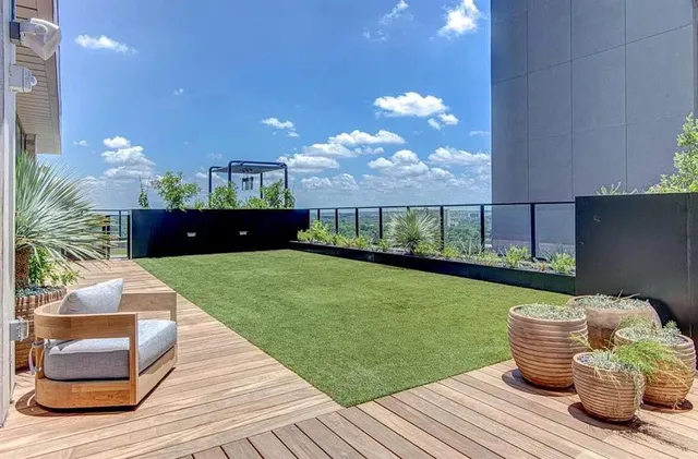a room with wooden floor table and chairs