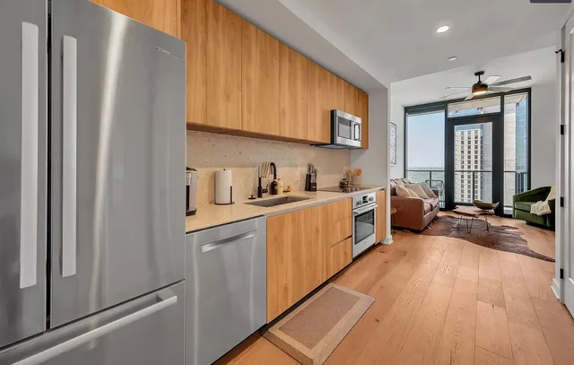 a kitchen with sink a refrigerator and cabinets