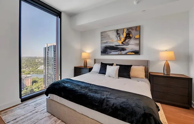 a bedroom with a bed and a painting on the wall