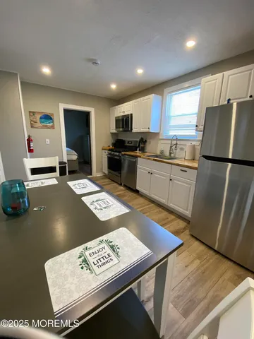 a kitchen with stainless steel appliances granite countertop a refrigerator sink and microwave