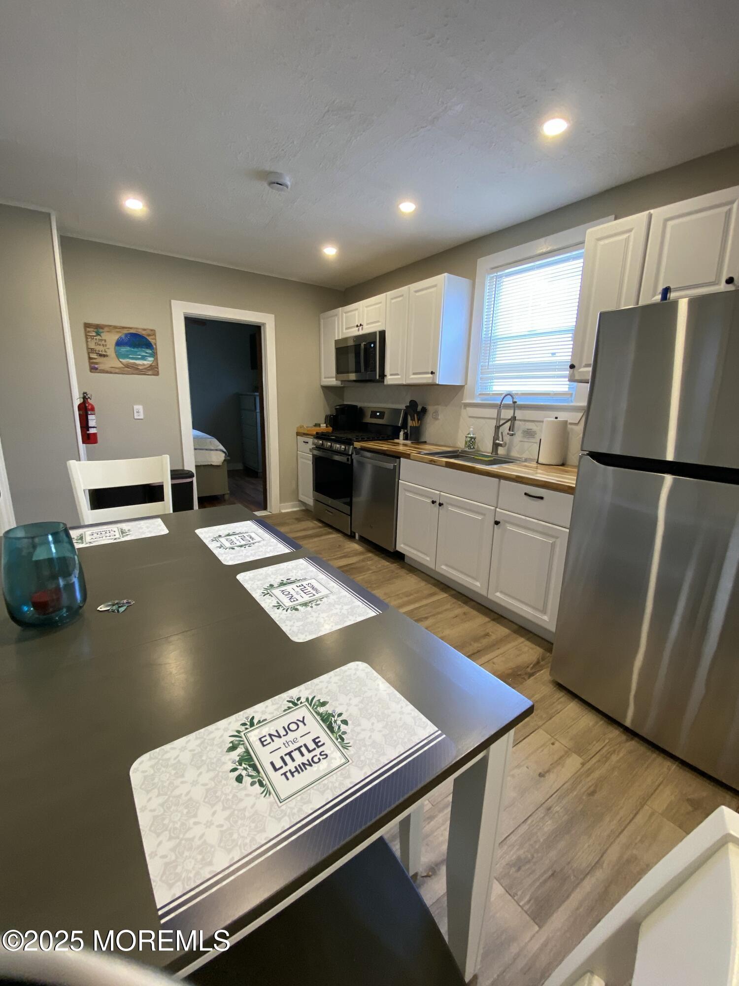 215 Webster Avenue, Unit 1 Seaside Heights, NJ 08751 - Photo 14 of 14 a kitchen with stainless steel appliances granite countertop a refrigerator sink and microwave