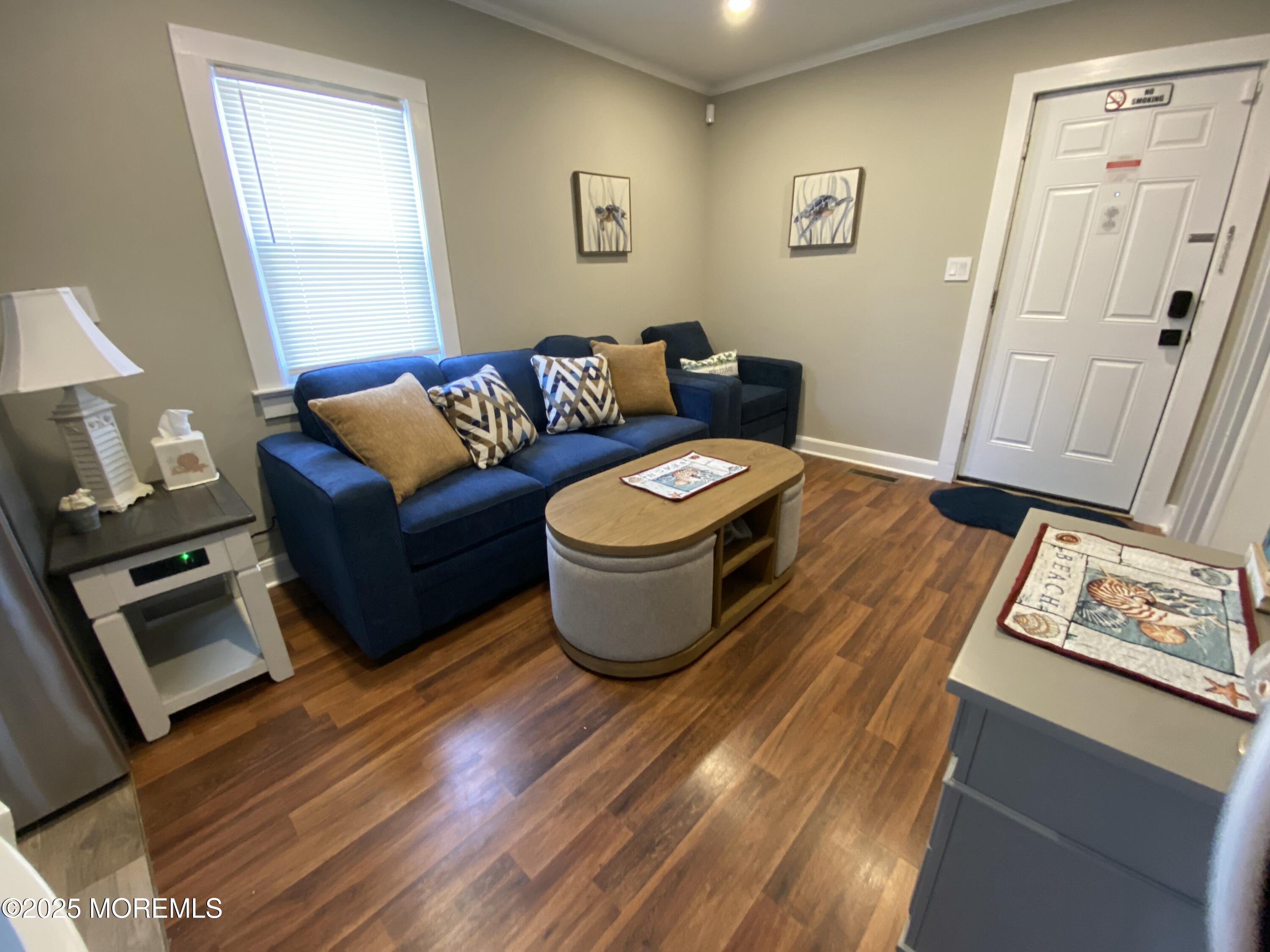 215 Webster Avenue, Unit 1 Seaside Heights, NJ 08751 - Photo 3 of 14 a living room with furniture and a window