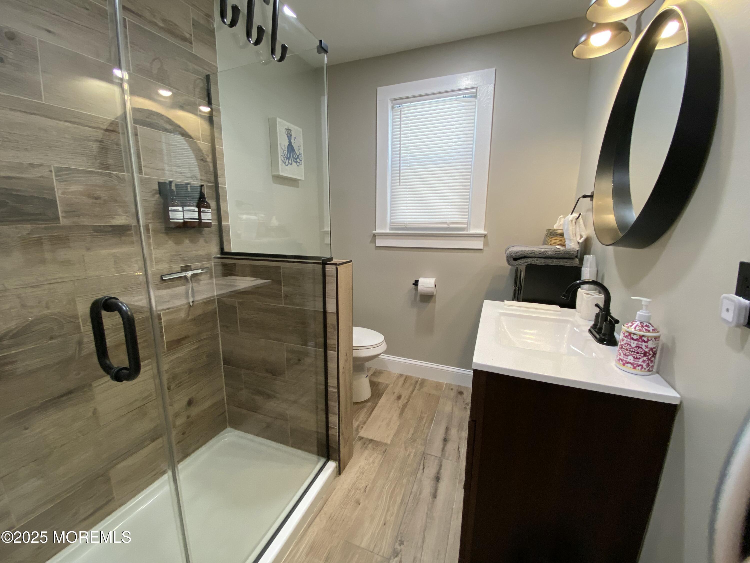 215 Webster Avenue, Unit 1 Seaside Heights, NJ 08751 - Photo 6 of 14 a bathroom with a sink a toilet and shower