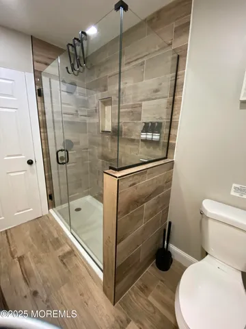 a bathroom with a shower a toilet and sink
