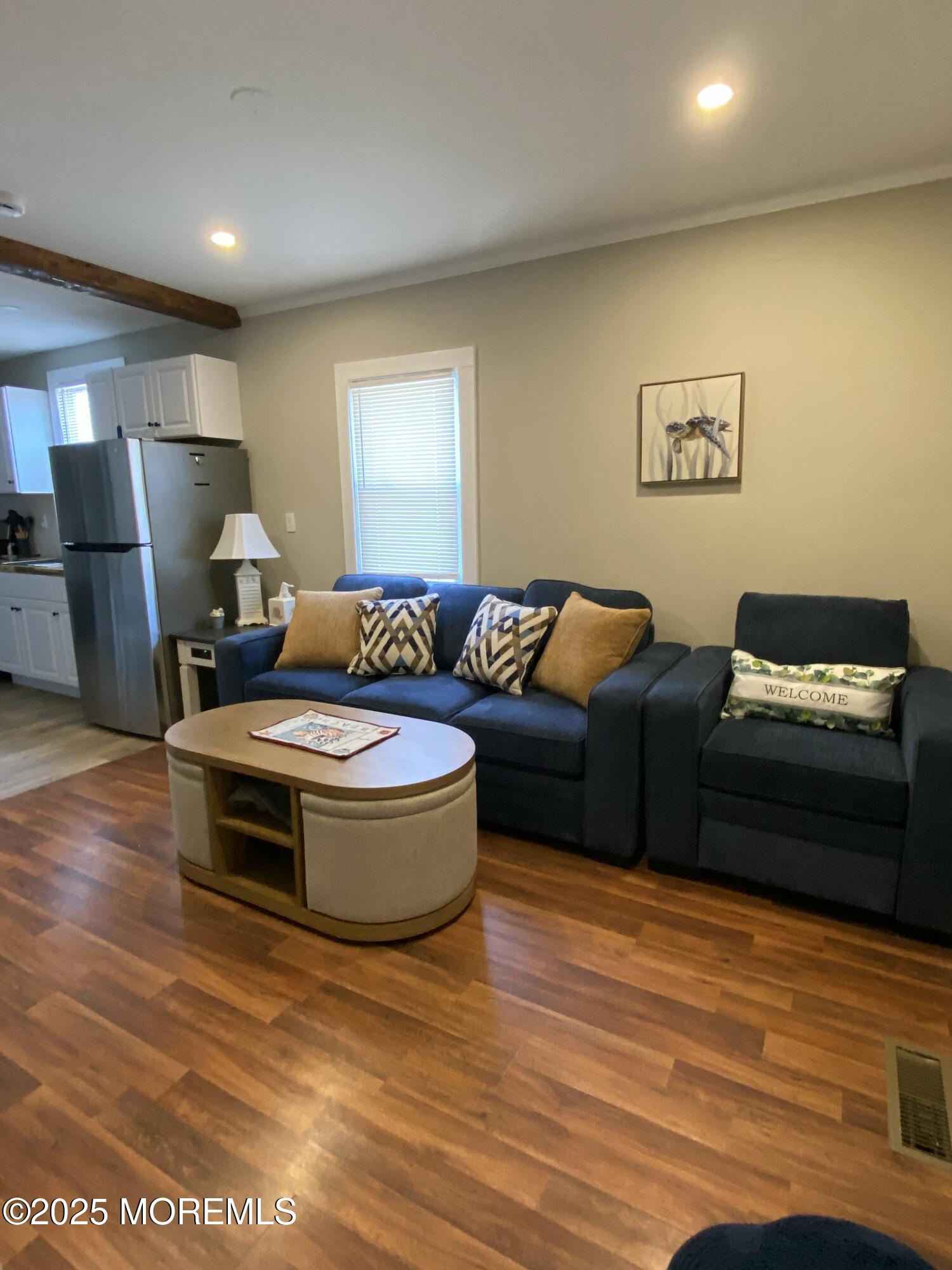 215 Webster Avenue, Unit 1 Seaside Heights, NJ 08751 - Photo 8 of 14 a living room with furniture and a wooden floor