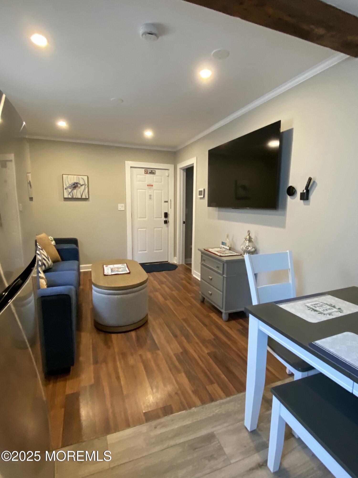 215 Webster Avenue, Unit 1 Seaside Heights, NJ 08751 - Photo 9 of 14 a living room with furniture and a flat screen tv