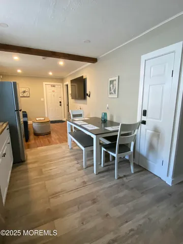 a dining room with furniture and a rug