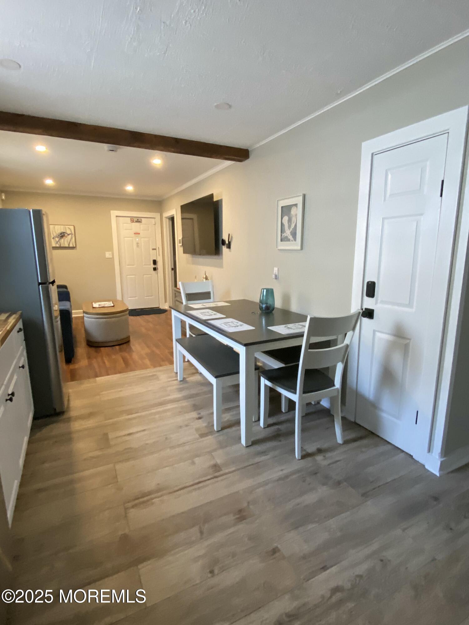 215 Webster Avenue, Unit 1 Seaside Heights, NJ 08751 - Photo 10 of 14 a dining room with furniture and a rug