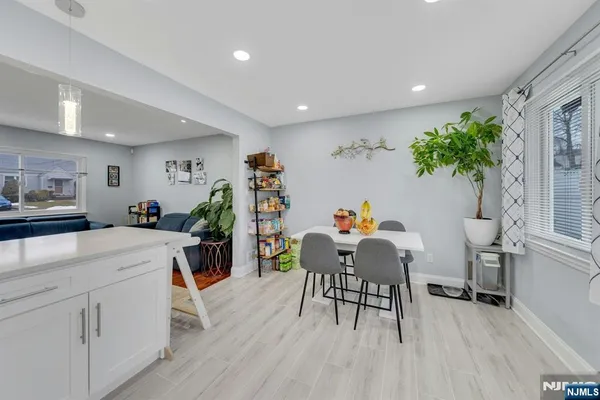 a dining room with furniture and a wooden floor
