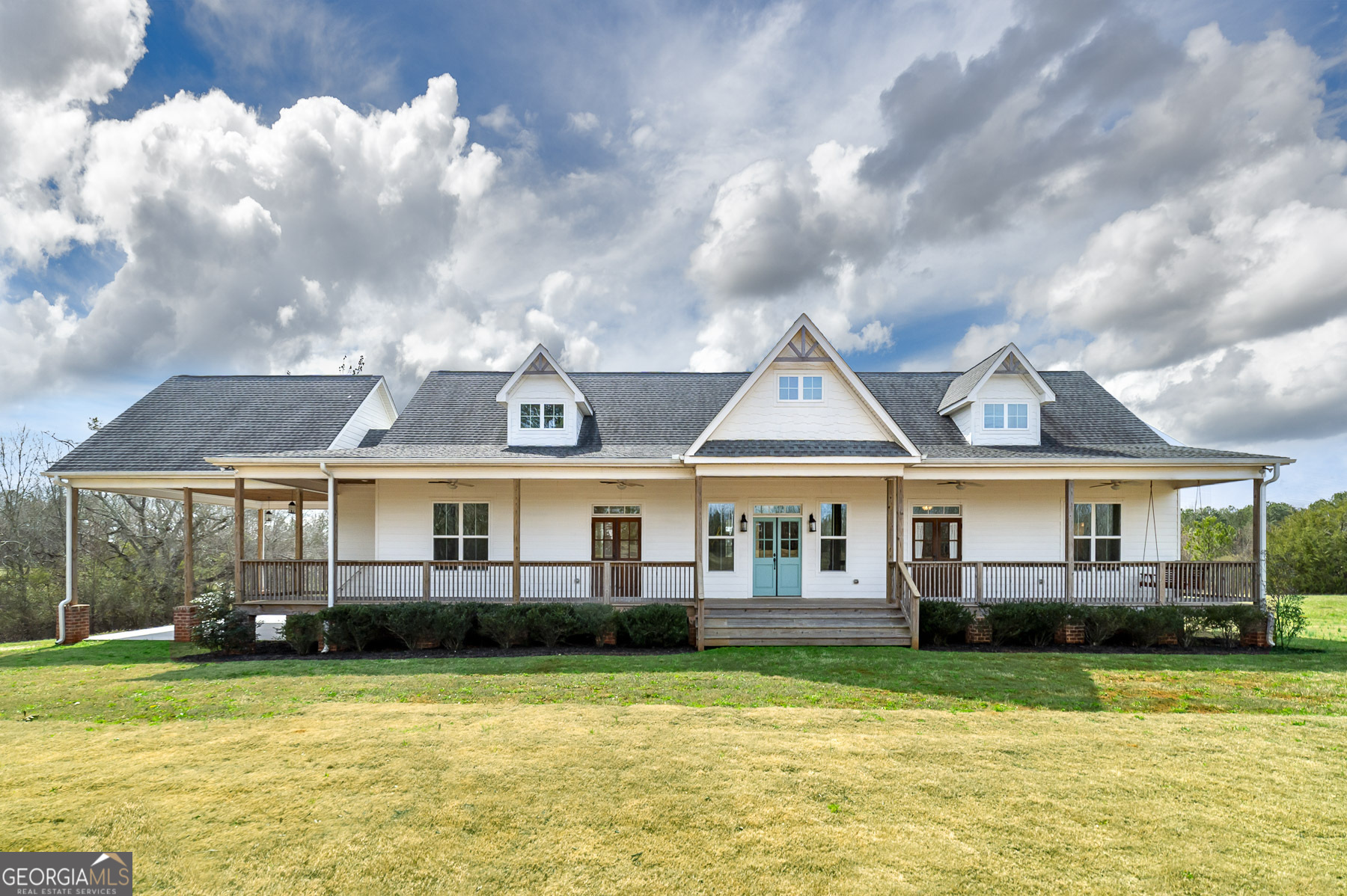 a front view of a house with swimming pool and porch