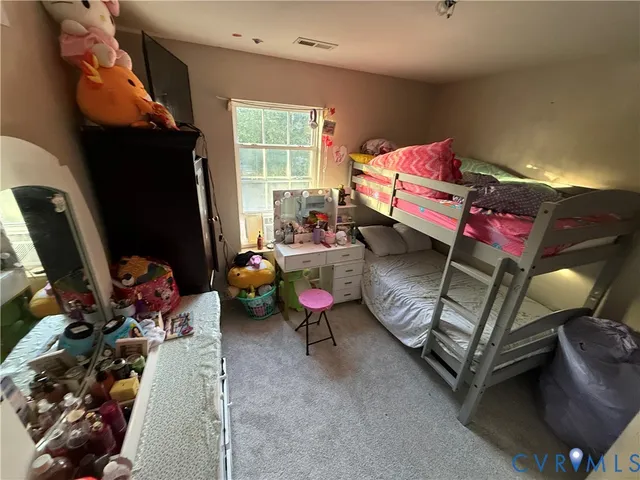 a bedroom with furniture and a window