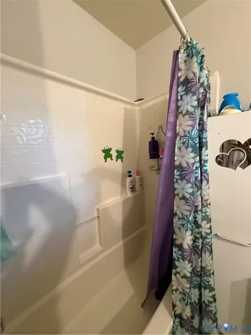 a bathroom with a bathtub and shower