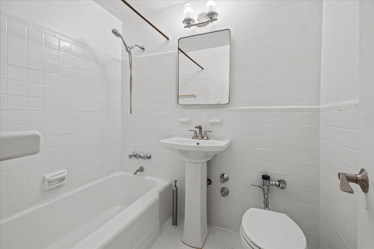 629 Kappock Street, Unit 1N Bronx, NY 10463 - Photo 9 of 12 a bathroom with a sink a toilet and shower