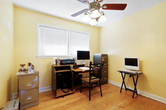a view of a workspace with furniture and a window
