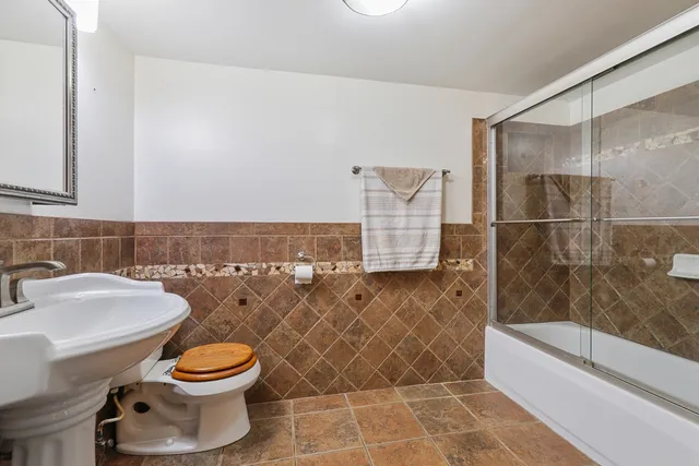 a bathroom with a toilet a sink and bathtub