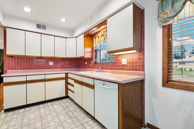 a kitchen with granite countertop sink and cabinets