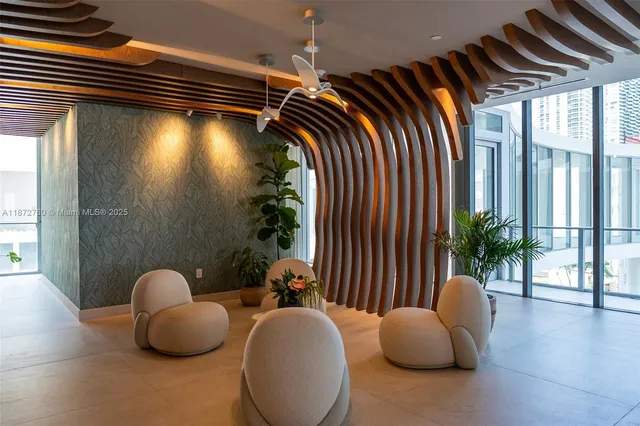 a view of living room with furniture and potted plants