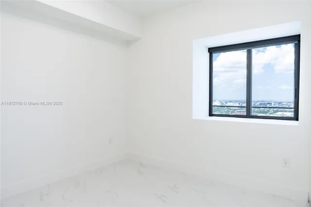 a front view of a building with a garden