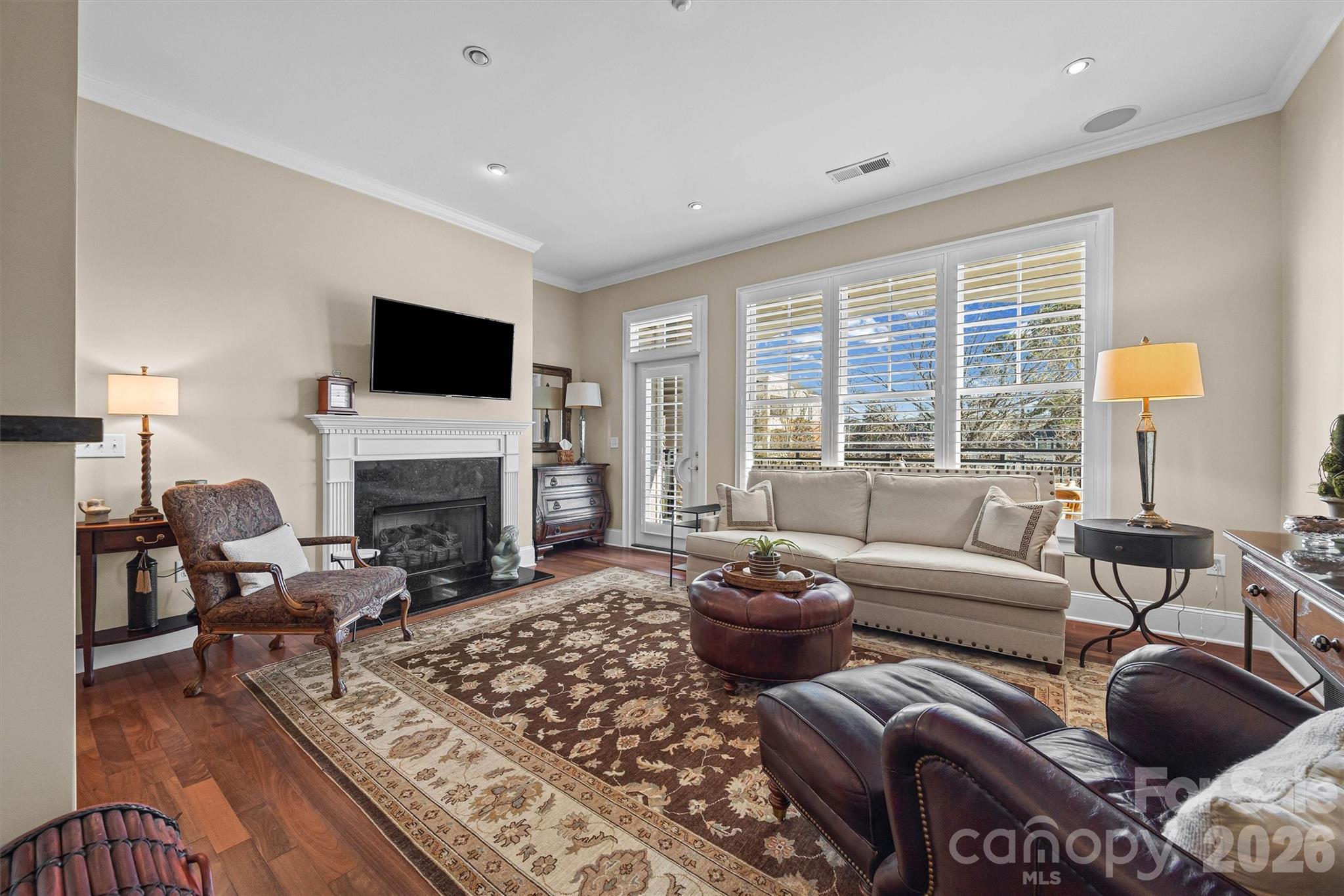 5425 Closeburn Road, Unit 214 Charlotte, NC 28210 - Photo 11 of 25 a living room with furniture a fireplace and a flat screen tv