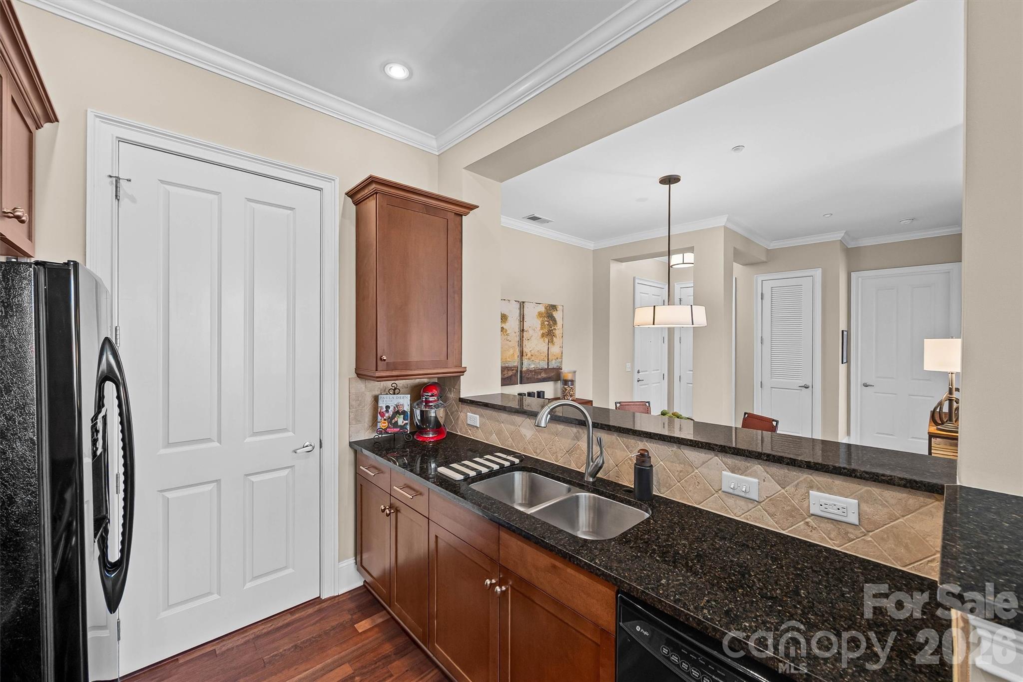 5425 Closeburn Road, Unit 214 Charlotte, NC 28210 - Photo 12 of 25 a kitchen with granite countertop a sink stainless steel appliances and cabinets