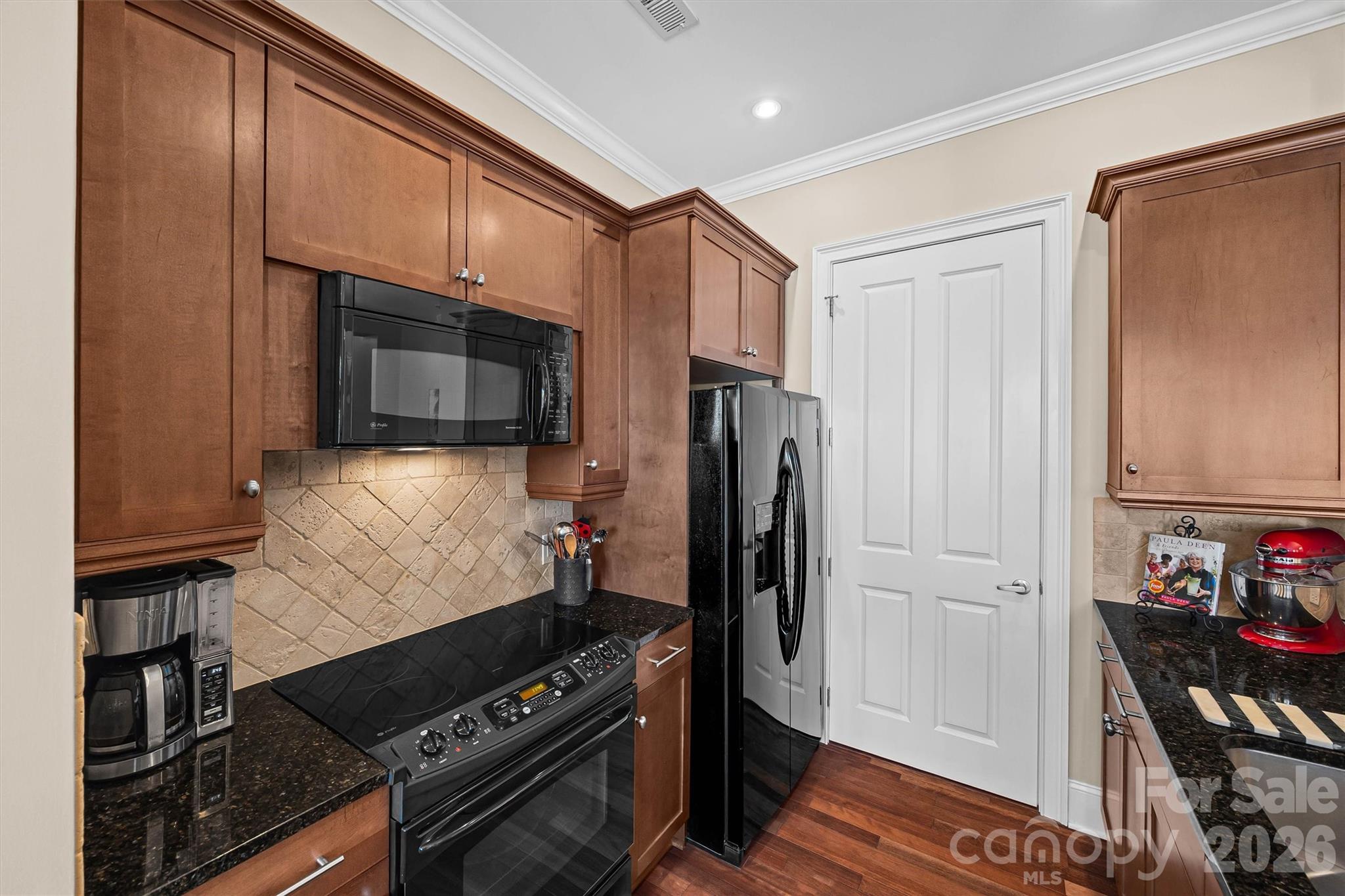 5425 Closeburn Road, Unit 214 Charlotte, NC 28210 - Photo 13 of 25 a kitchen with stainless steel appliances a refrigerator and a stove top oven
