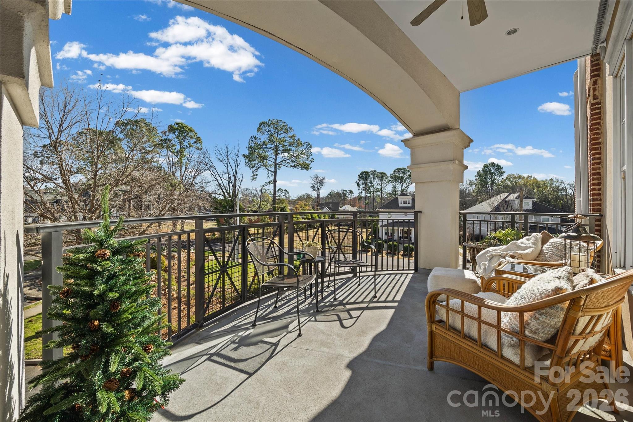 5425 Closeburn Road, Unit 214 Charlotte, NC 28210 - Photo 21 of 25 a balcony with chairs and wooden floor