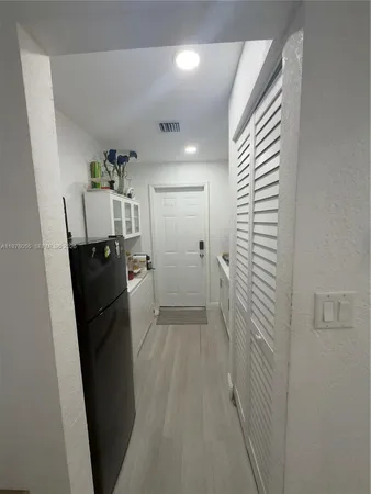 a view of a storage & utility room with refrigerator washer and dryer