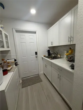 a kitchen with a sink and cabinets